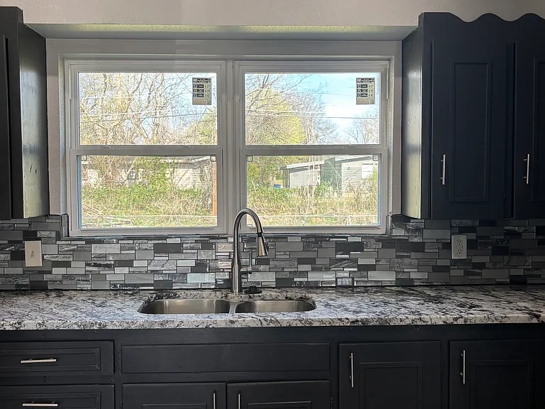Updated kitchen with all new windows, hardware, flooring, lighting, and new Stainless Steel Appliances.