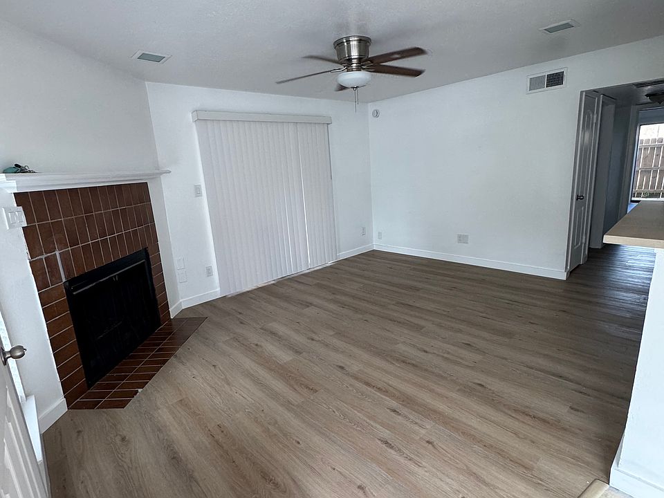 Large living room with patio space and fire place.