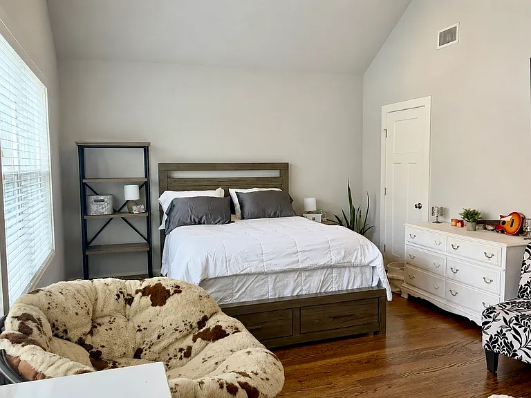 Second upstairs bedroom - another huge room with vaulted ceilings, two closets, and ensuite bathroom. *NOTE: house comes unfurnished (pics show current owner's furnishings that will be moved).*