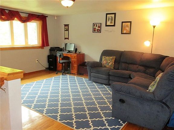 The living room sits on the main level of the home and is furnished with beautiful hardwood floors and accented with a gorgeous 
