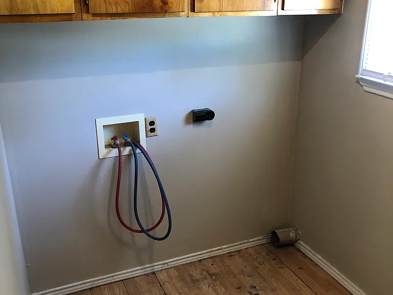 Separate laundry room with hookups and ample cabinet space.