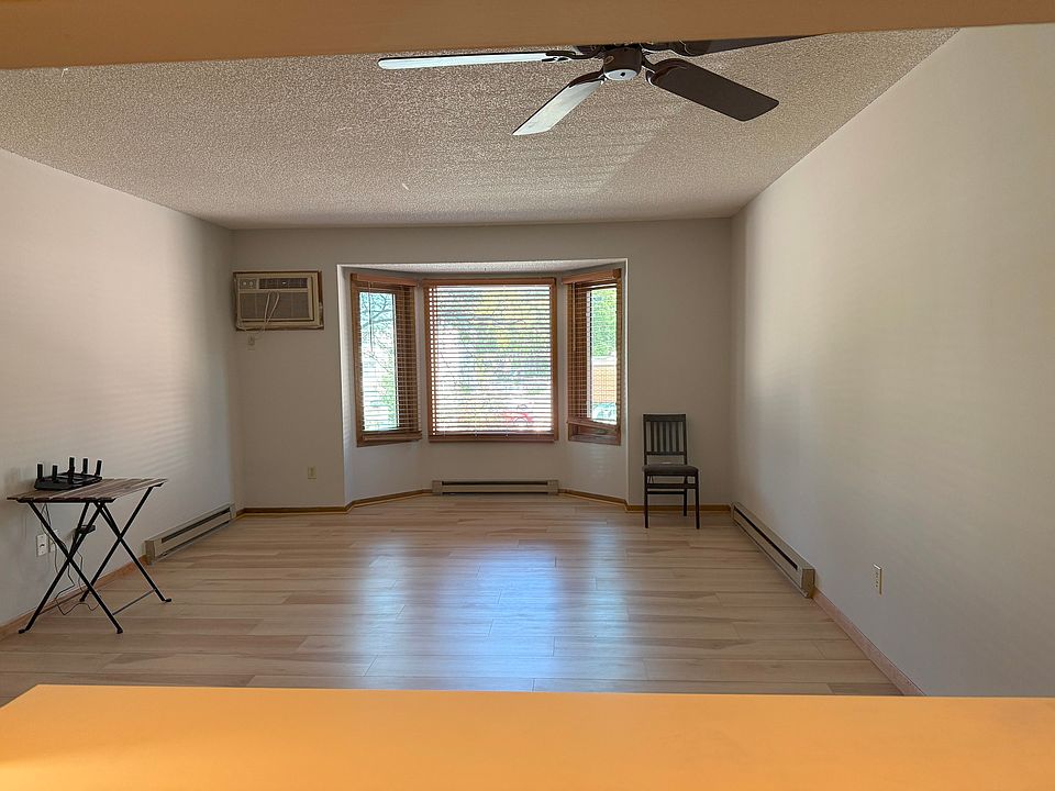 Living Room with Ceiling Fan, AC and new flooring. New Windows in Living Room and Bedrooms