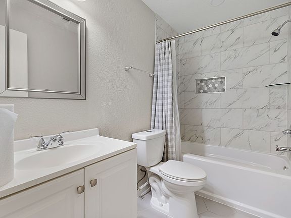 Remodeled common bathroom with a tub