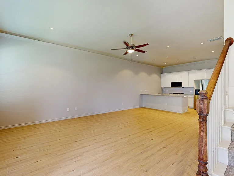 Open Concept Living, Dining, and Kitchen with Crown Molding