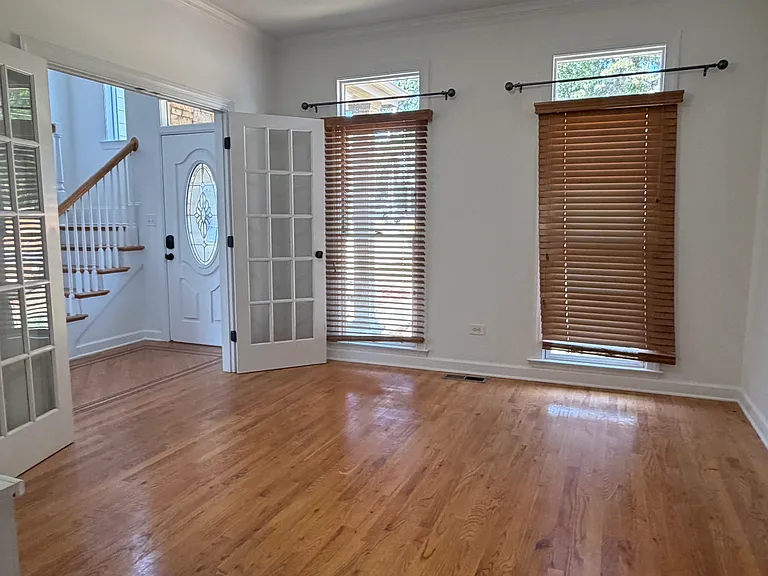 This first-floor dining space flows right off the kitchen, with warm hardwood floors and natural light filtering through wood blinds_set a large table for holiday feasts or use it as a flexible space for game nights and family gatherings.