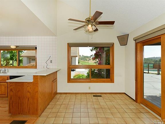 Kitchen with breakfast bar & doors to deck