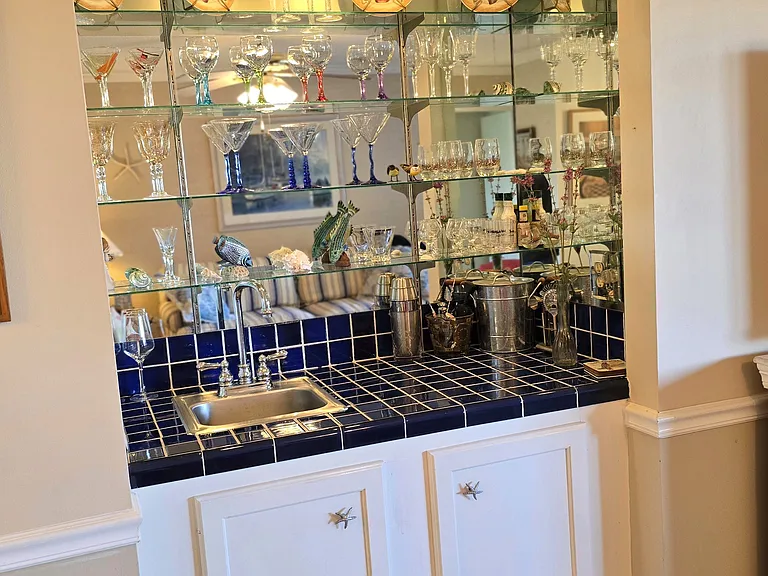 Wet Bar fully stocked with glasses and bar tools