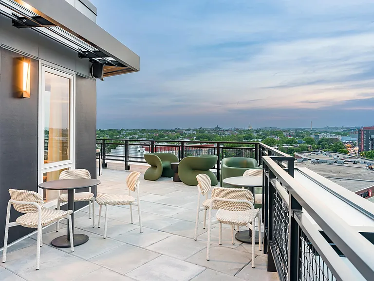 Start your day or wind it down on the rooftop terrace_featuring cozy seating, open skies, and sweeping views of the Capitol skyline.