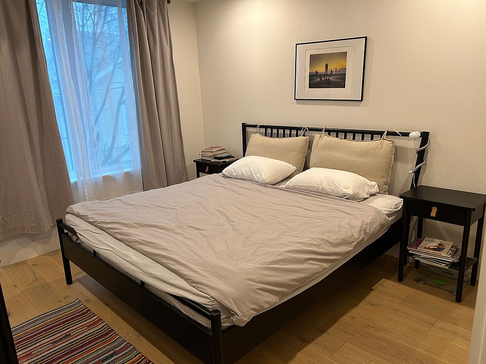 Bedroom has king-sized bed and comes with dresser; closet (not seen) has shelves for extra storage.