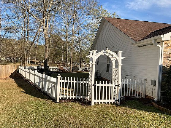 Side yard with lit Arbor.