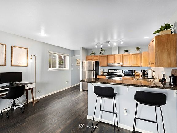 Updated laminate floors throughout make the unit feel spacious. 