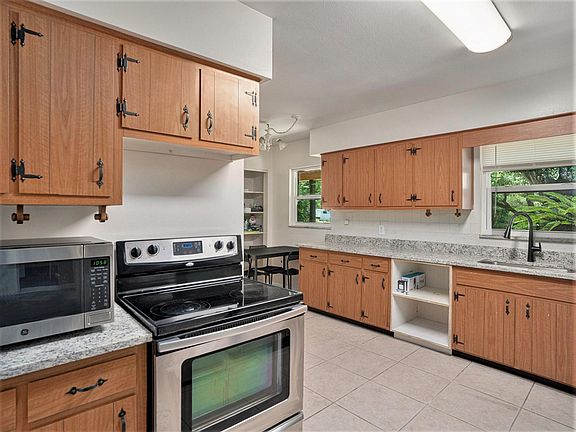 Our kitchen features a dining area and modern appliances, perfect for preparing and enjoying home-cooked meals.