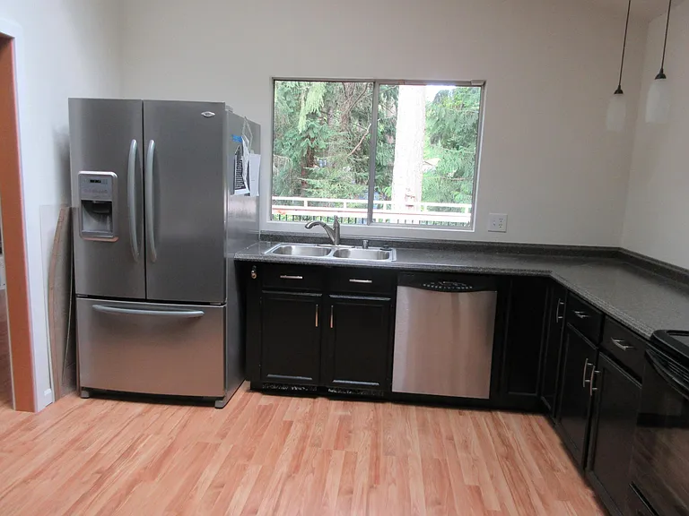 Kitchen w/ Skylight / Greenbelt View & Deck