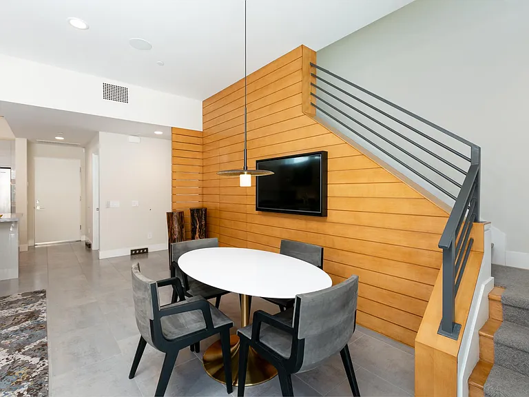 Staircase to the second story bedrooms and office area. Indoor dining can seat six with extra chairs.
