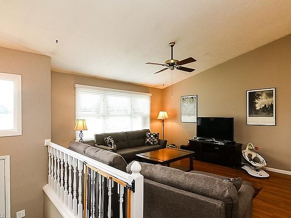 Living room off Kitchen. New double-hung windows and sliders, new 2" white blinds installed throughout home.