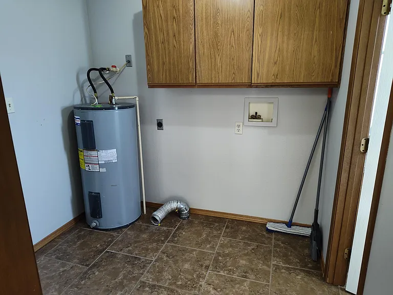 Laundry room off kitchen. Washer and dryer hookups. Downstairs 1/2 bath to the right. Garage to the left.