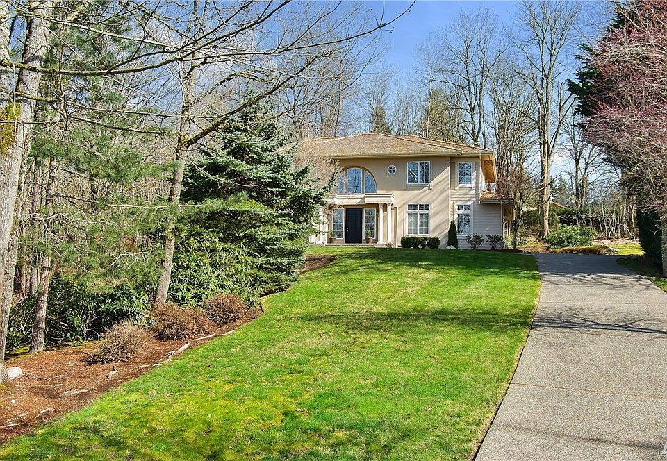Perched on a shy 2-acre lot, set well off the road with a 3 car side-turned garage.