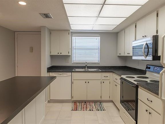 Extra storage under bar and new modern kitchen tile.