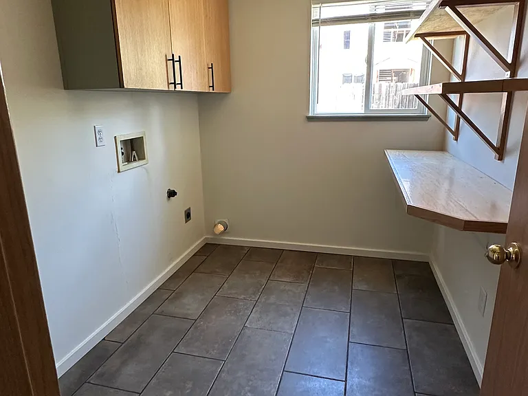 Laundry room, with nice wood built-in storage shelving, 1/4 sawn oak cabinet fronts.