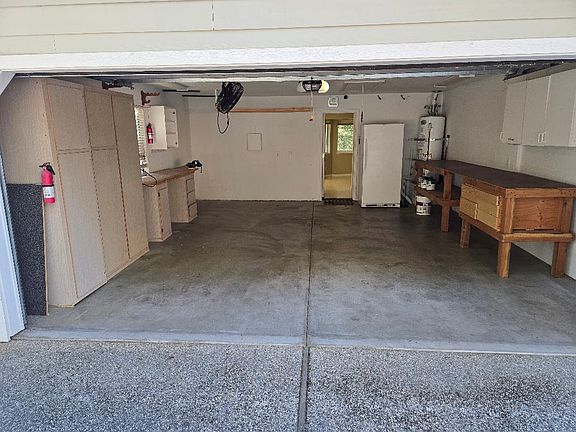 Inside of Garage, extra freezer and storage/work benches