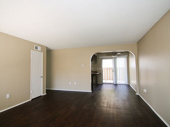 Living room looking into dining/kitchen/balcany