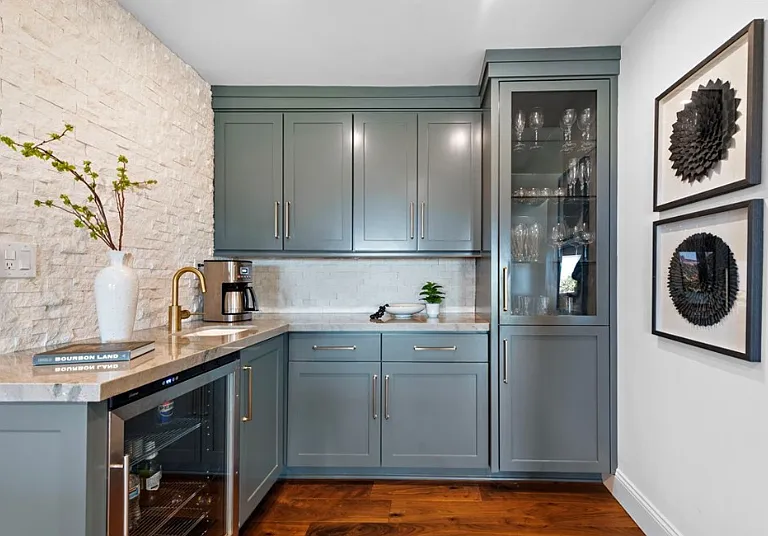 Stylish wet bar with wine fridge and sink.