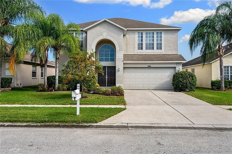 Front Exterior - Freshly painted front doors and tropical landscaping