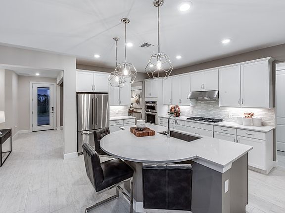 Kitchen with rounded island and stainless appliances