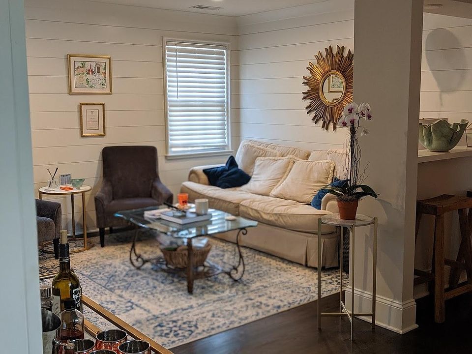 Living room featuring new hardwoods and shiplap walls.