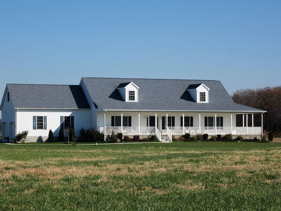 Cape Cod with wrap around porch.