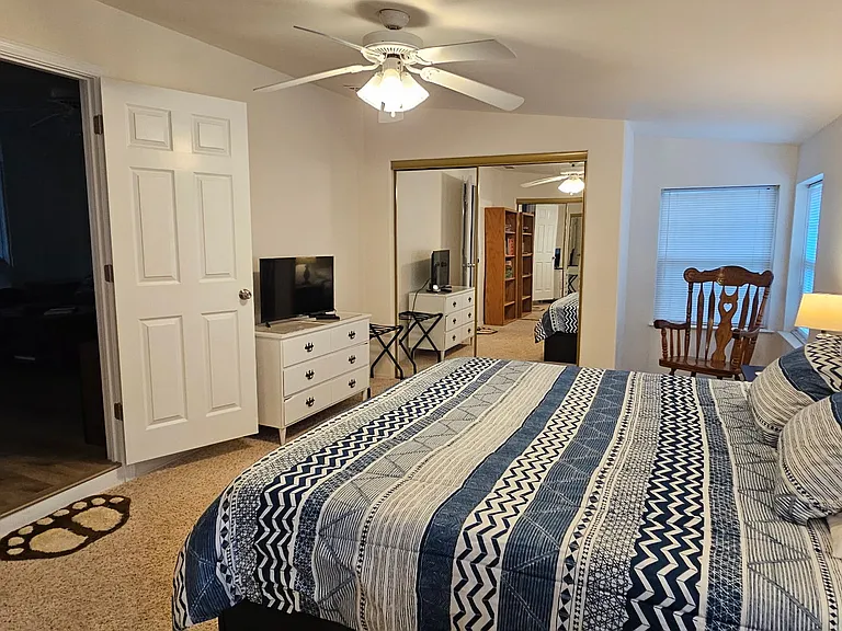 Bedroom with 2 closets, and dresser.