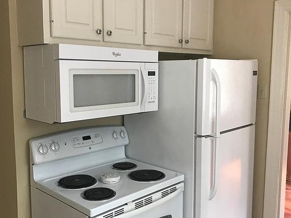 The refrigerator, range, and microwave which are opposite the sink. Look at all the cabinets!