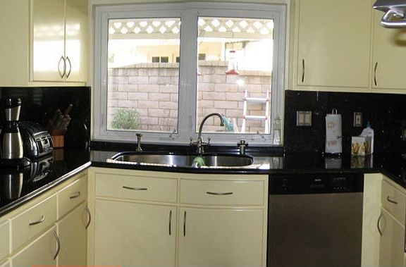 The updated kitchen has granite countertops and stainless steel appliances.