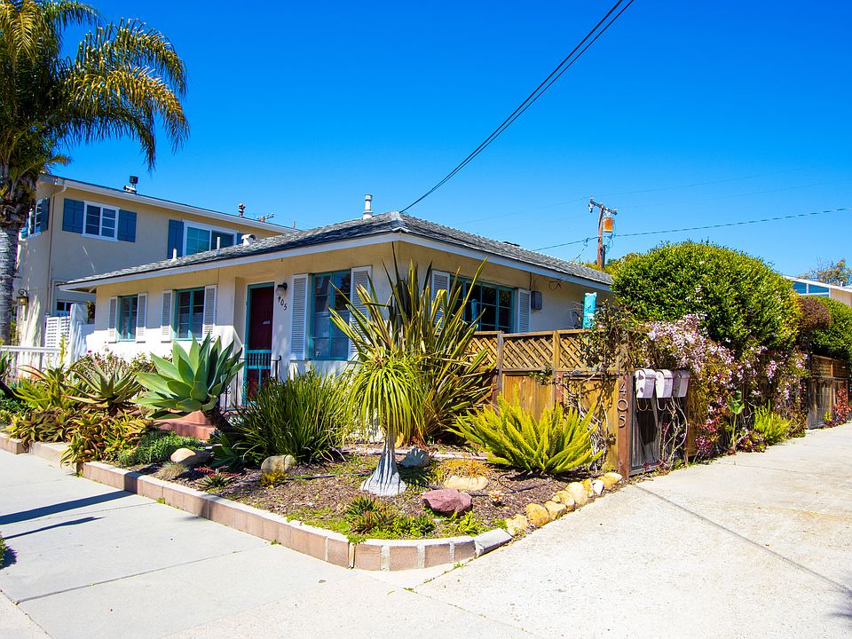 Middle apartment entrance is between two tall shrubs on left.