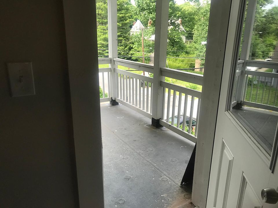 Covered porch overlooking the street, attached to kitchen and dining area. Set among the trees, enjoy the neighborhood!