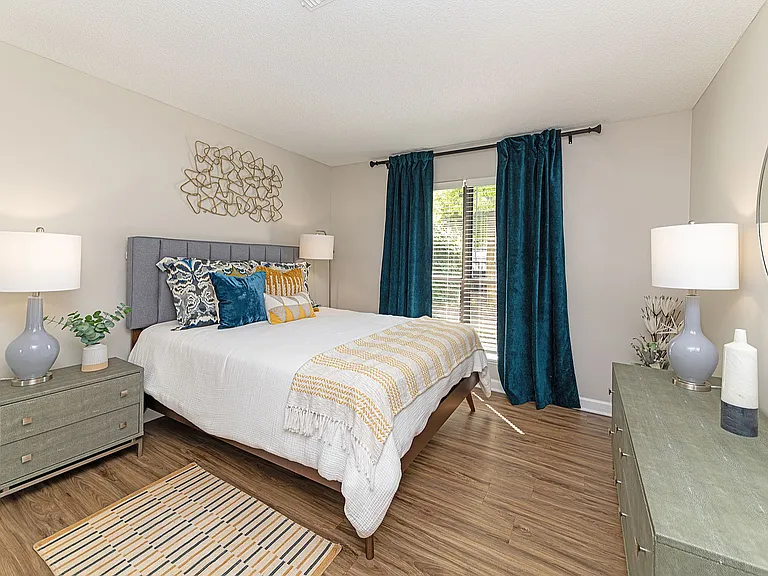 Cozy bedroom with hardwood-style flooring and ceiling fan