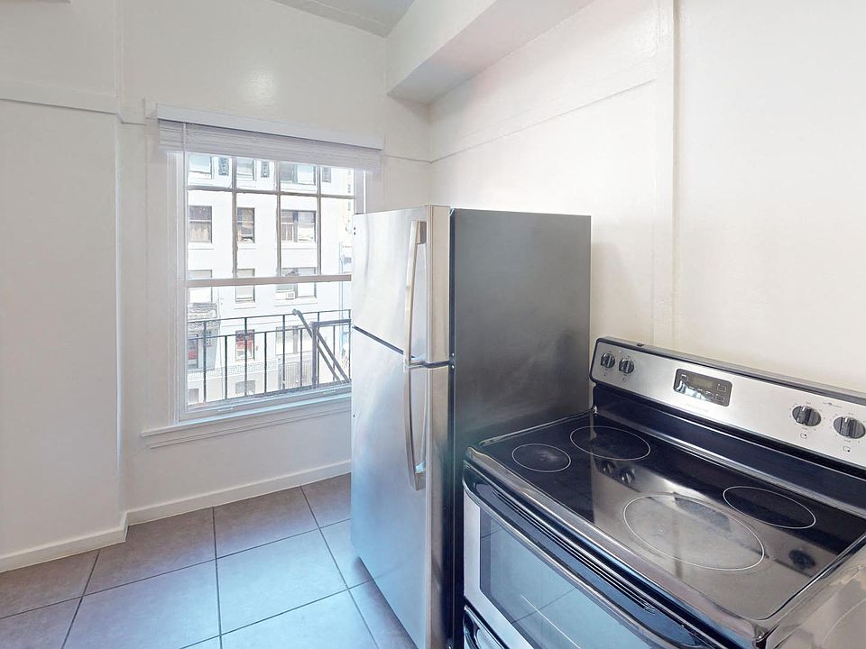 Kitchen with a stove, refrigerator and window