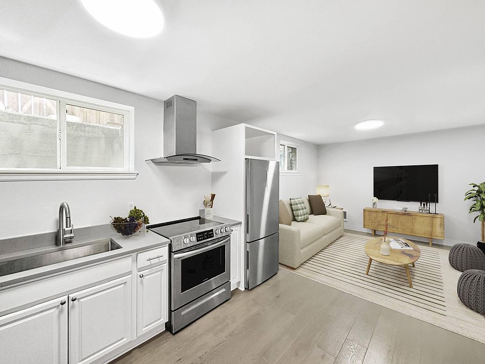 Remodeled sleek kitchen opens to living space.
