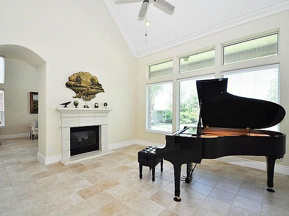Formal living has gas log fireplace and large windows