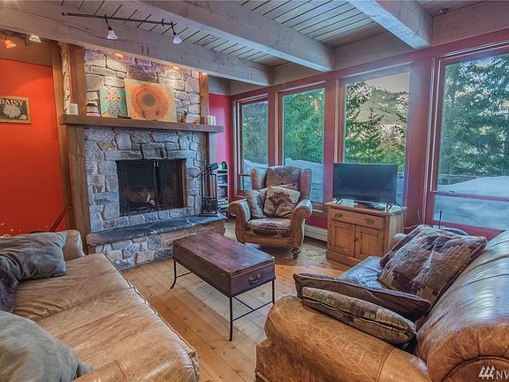 Great room features include this living space with picturesque windows & wood burning fireplace.  Enjoy the views, which are amazing in all seasons!
