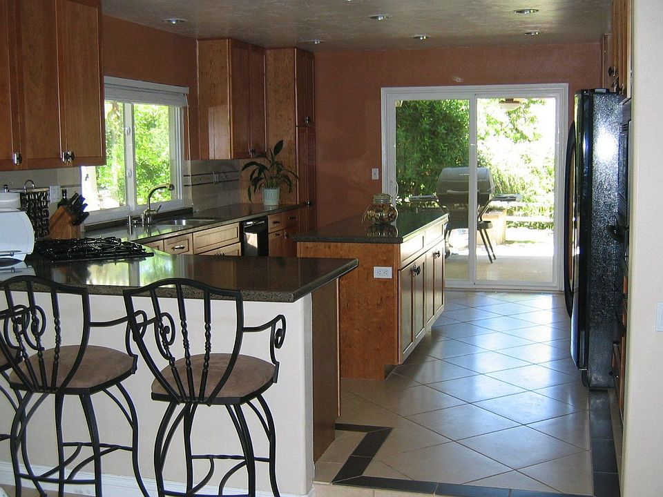 Kitchen with cherry cabinets, Silestone countertops, italian marble backsplash