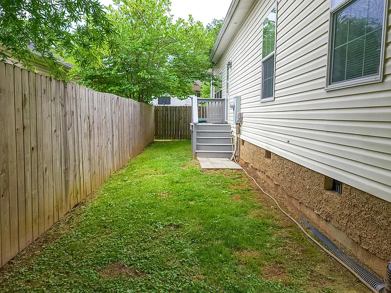 Let the pups roam free in the fully enclosed back yard. Stairs lead into the laundry room.