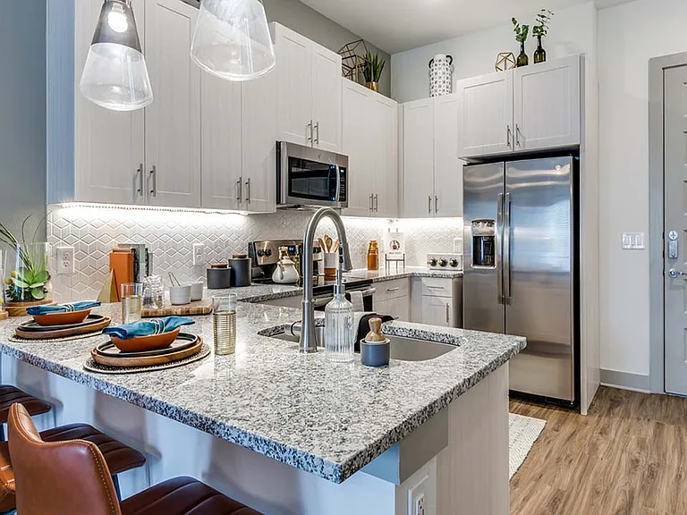 Griffis Frisco apartment kitchen with stainless steel appliances.