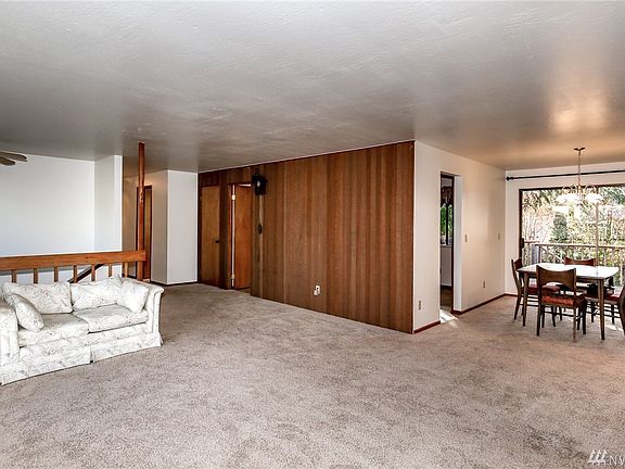 Living and dining room. The kitchen is behind the wood paneled wall.