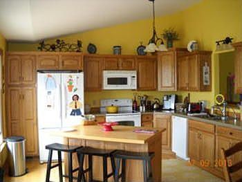 Lets walk on thru the kitchen and check out the many cupboards and counter space offered, along with a middle island for storage and sitting.