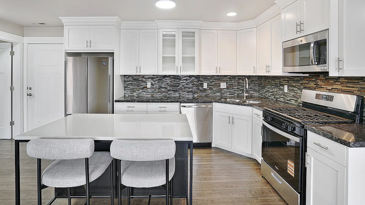 Open kitchens with islands provide space for cooking, dining, and entertaining. - Junction View