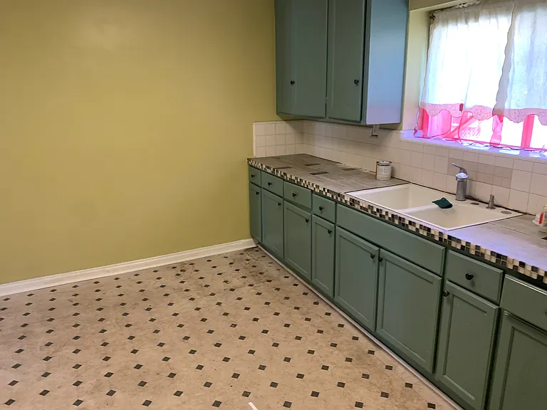 Large kitchen with space for small kitchen table.
