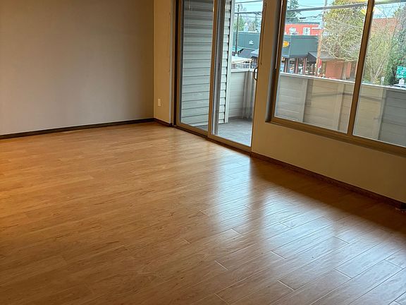 living room looking out toward sliding door and large balcony
