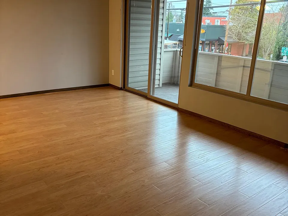 living room looking out toward sliding door and large balcony