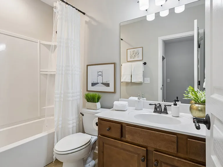 A well-appointed full bath serves the lower-level living spaces, providing comfortable accommodations for guests & everyday convenience.